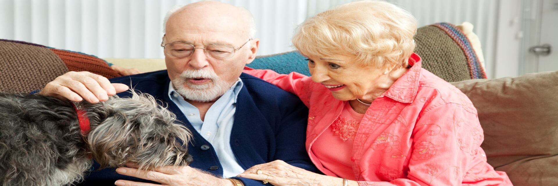elderly man and woman with dog